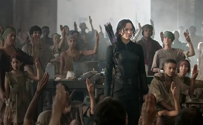 Where to watch The Hunger Games scene still showing an intense arena moment with Katniss during the Games
