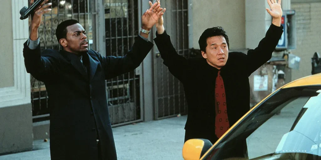 Where to watch Rush Hour scene still showing a fast-paced action moment with the two lead characters